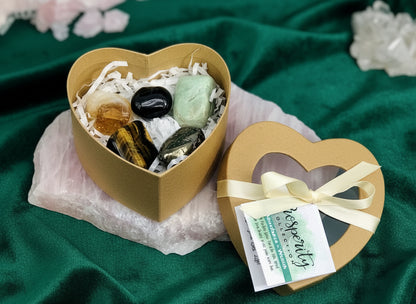 Heart-shaped gift box with bath bombs and a tag on a white surface
