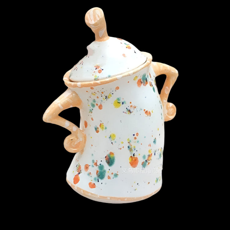 Ceramic jar with colorful splatter design on a white background