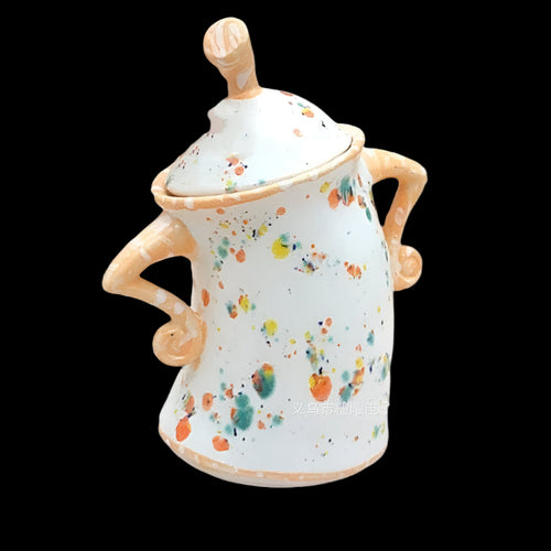 Ceramic jar with colorful splatter design on a white background