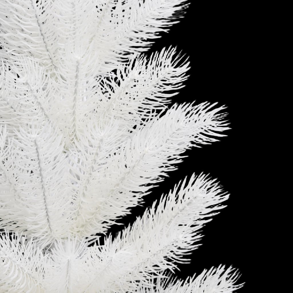 Close-up of white artificial Christmas tree branches against a black background