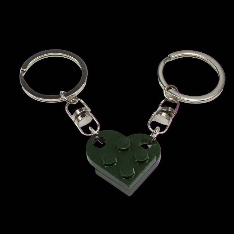 Green heart-shaped keychain with metal rings on a white background