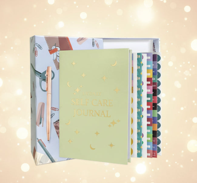 Set of self-care journals with a green journal, colorful divider sheets, and packaging on a white background.