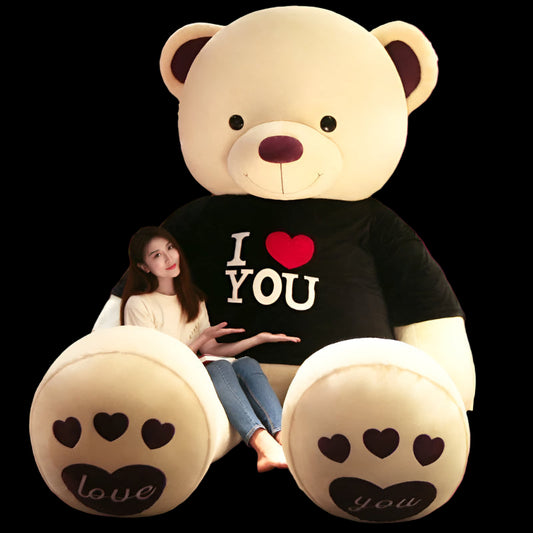 Large teddy bear with 'I §OU' shirt in a store setting