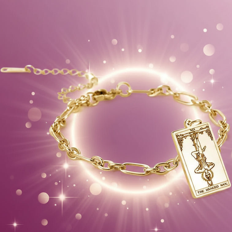 Gold bracelet with tarot card charm on a white background