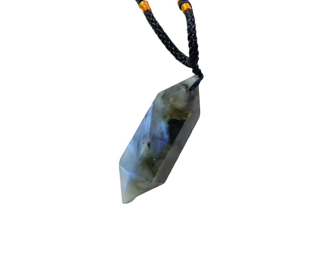 Crystal pendant on a white marble surface with a soft focus background