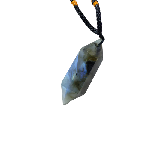 Crystal pendant on a white marble surface with a soft focus background