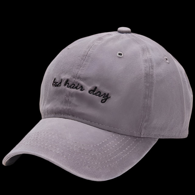 Gray cap with 'bad hair day' text on a white background