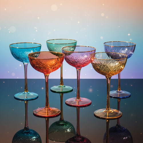 Set of colorful cocktail glasses on a dark surface with a dark background