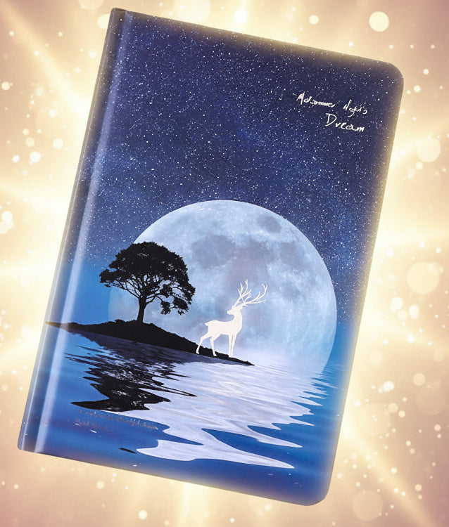 Notebook with a deer and tree design on a dark background