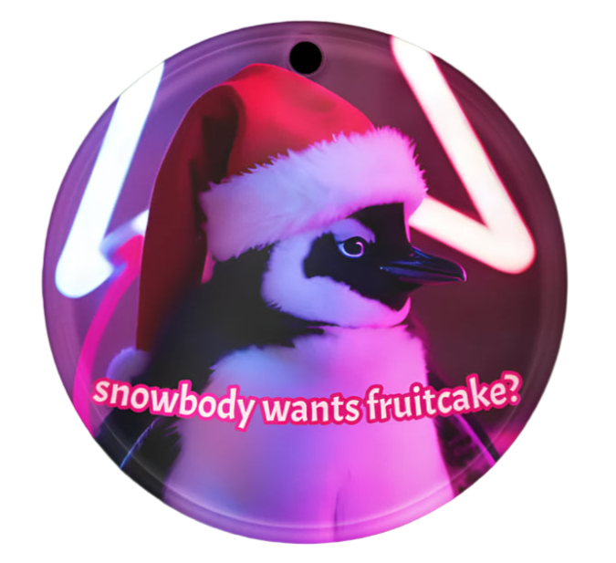 Circular ornament with a penguin wearing a Santa hat and text 'snowbody wants fruitcake?' on a white background.