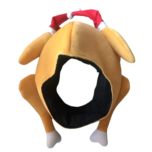 Dog-shaped plush toy with a Santa hat on a textured surface