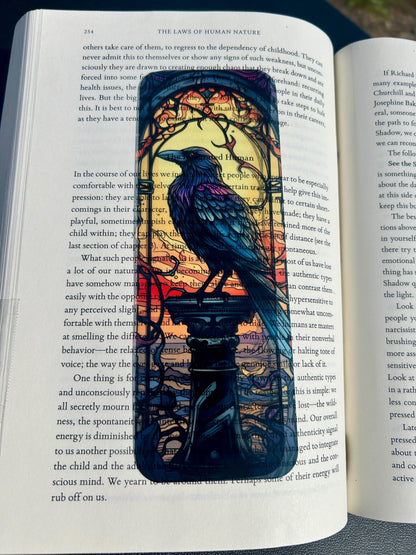 Decorative bookmark with a crow design on an open book