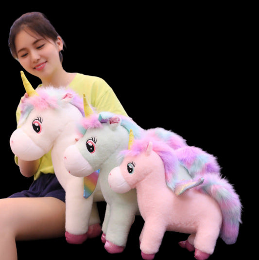 Person holding three colorful unicorn plush toys in a room with bookshelves.