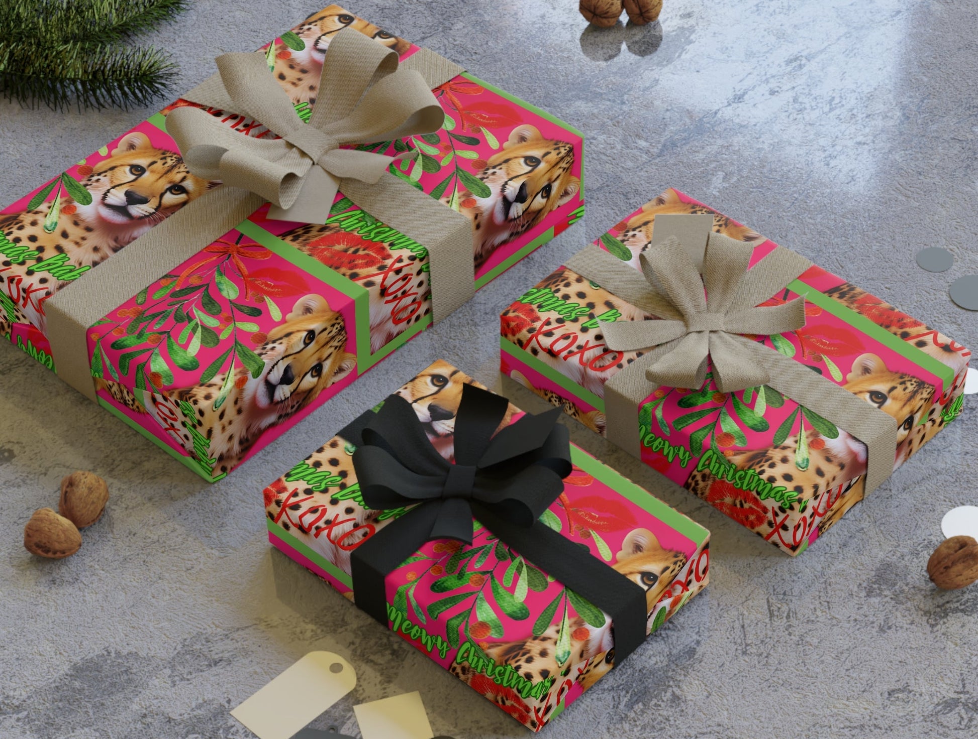 Three gift boxes with colorful leopard print wrapping paper and ribbons on a gray surface.