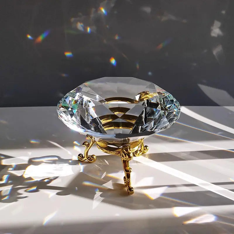Crystal object with gold base on a reflective surface