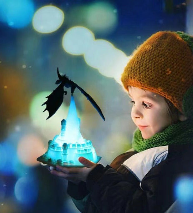 Child holding a glowing blue crystal with a dragon silhouette against a blurred, colorful background
