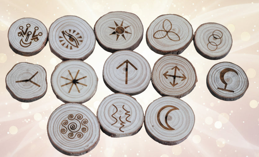 Set of wooden discs with engraved symbols on a black background