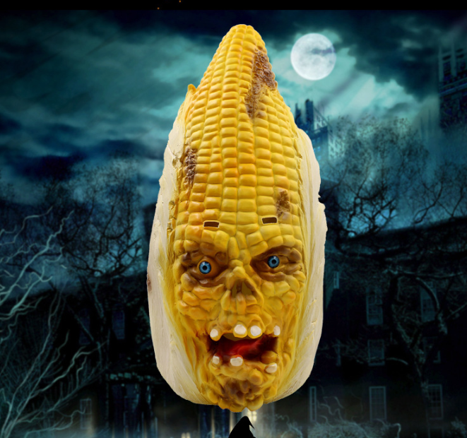 Corn on the cob with a恐怖 face design against a dark, spooky background