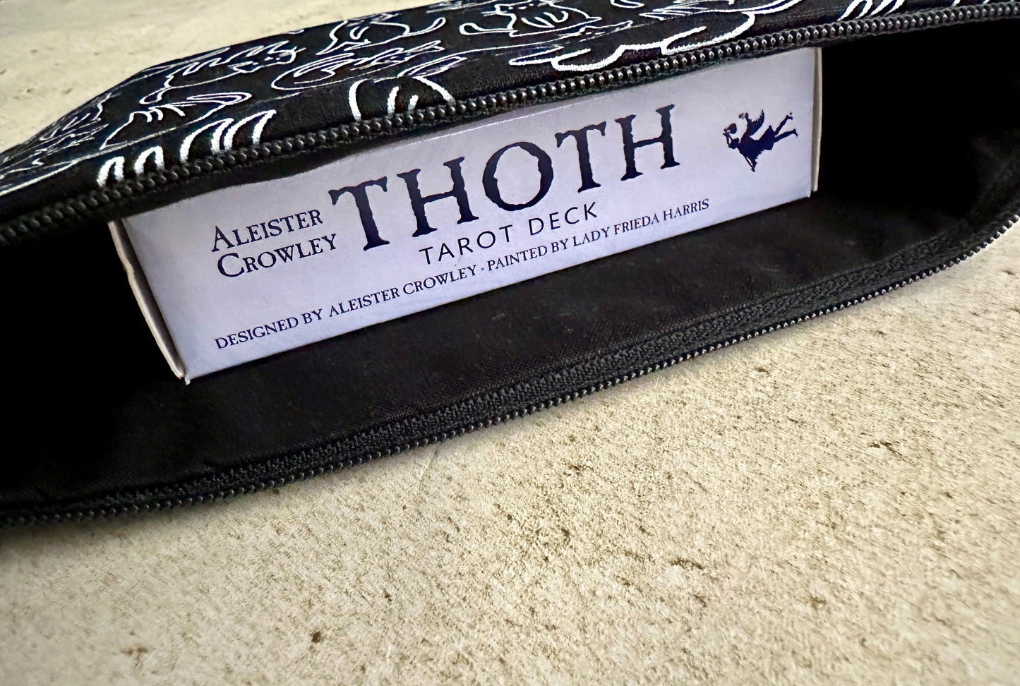Thoth Tarot Deck packaging with Aleister Crowley branding on a textured surface