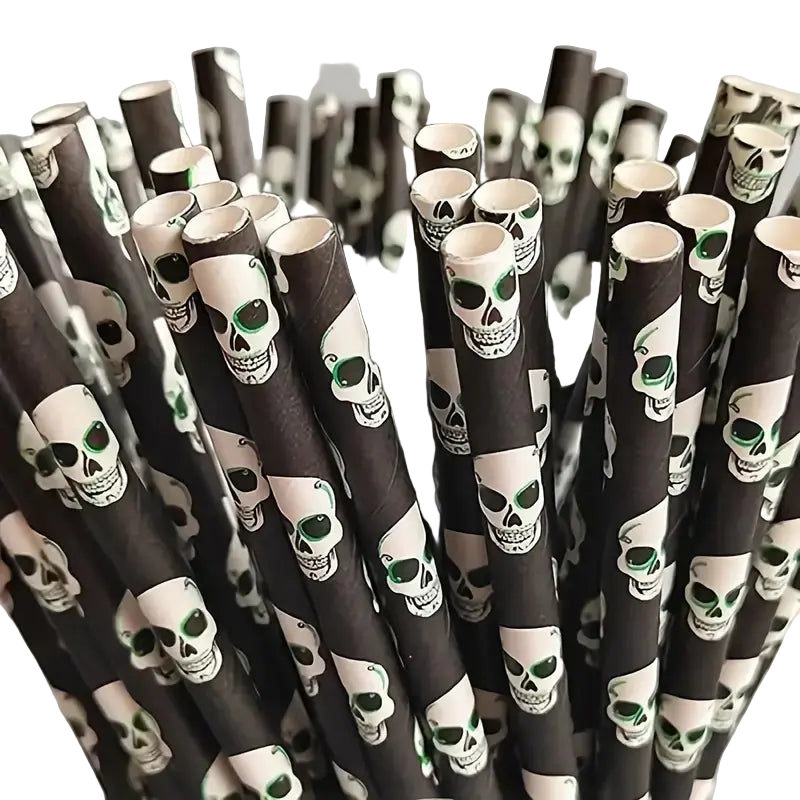 Black paper straws with skull designs on a gray background