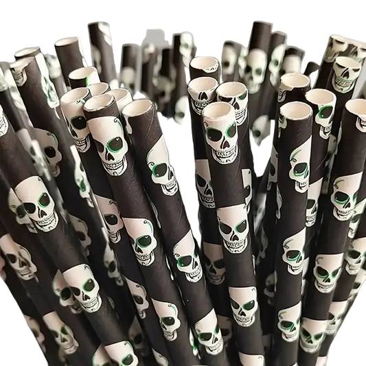 Black paper straws with skull designs on a gray background