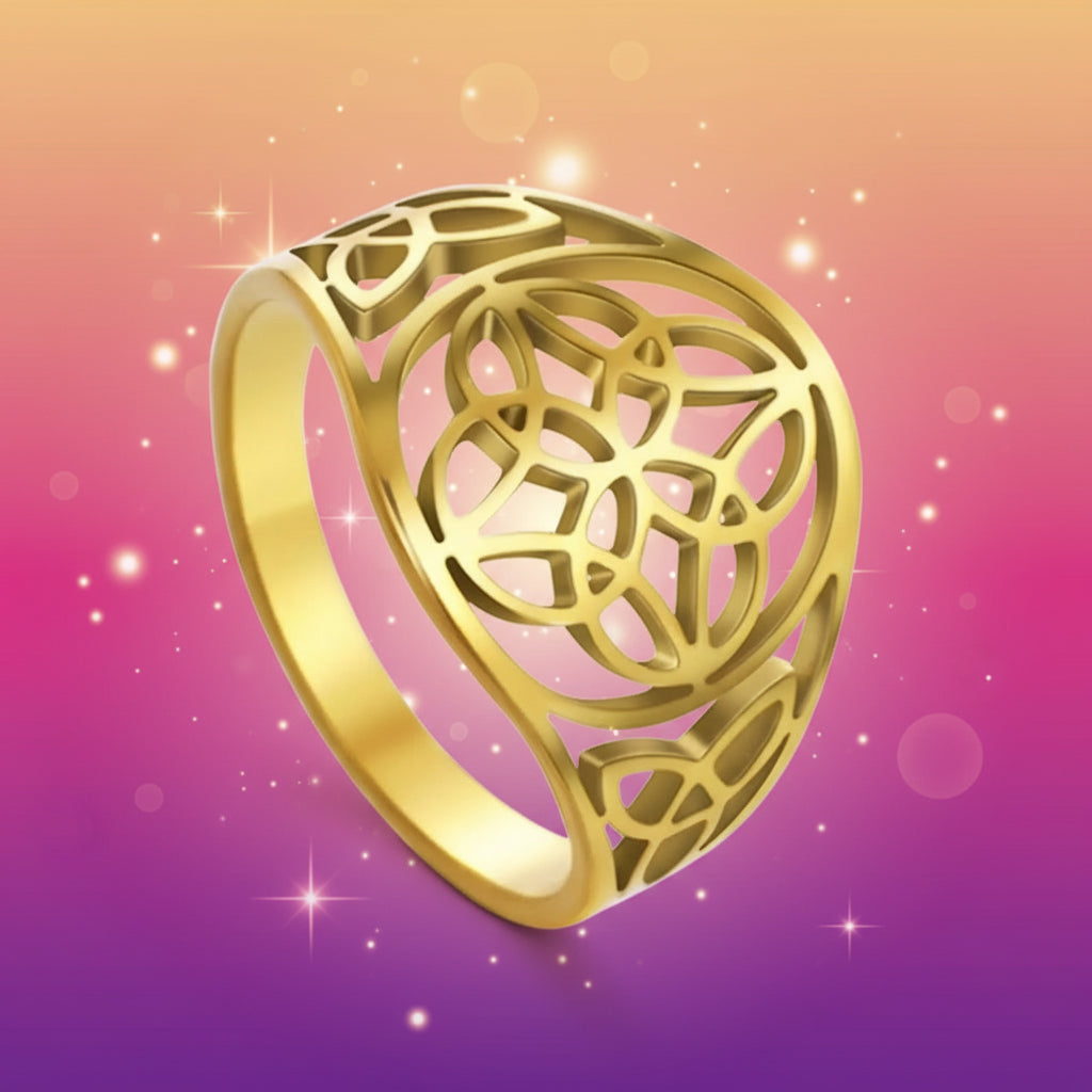 Gold ring with intricate design on a white background