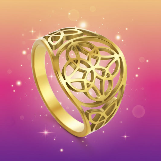 Gold ring with intricate design on a white background