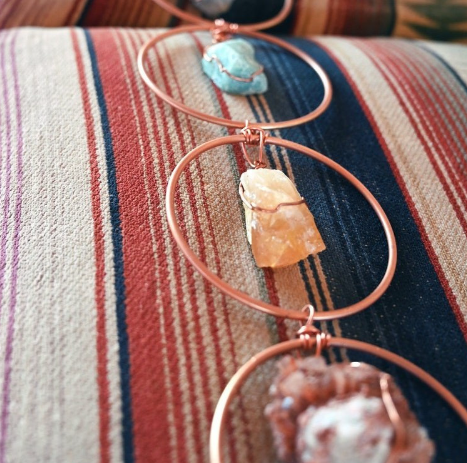 Necklace with stone pendants on a striped fabric background