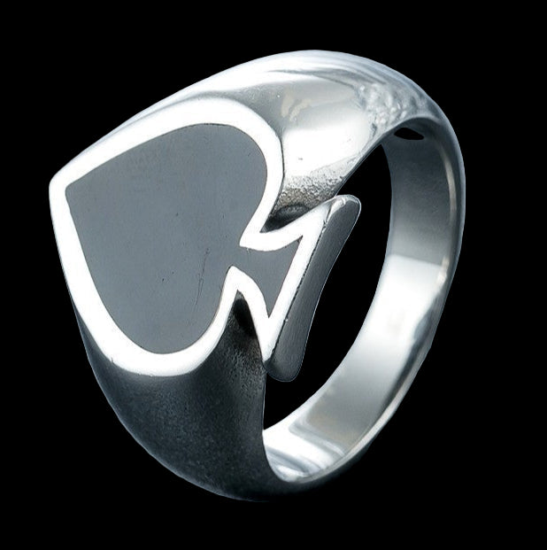 Silver ring with a unique design on a reflective surface