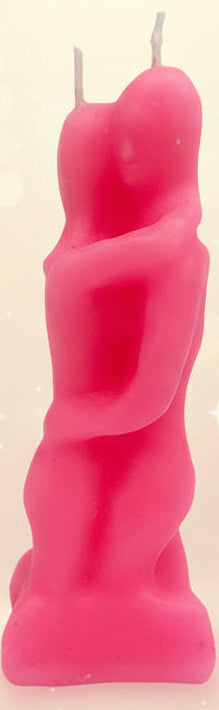 Pink candle shaped like a person on a plain background