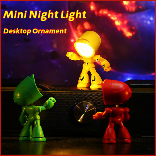 Three colorful robot figurines with a yellow one glowing as a mini night light on a dark background.