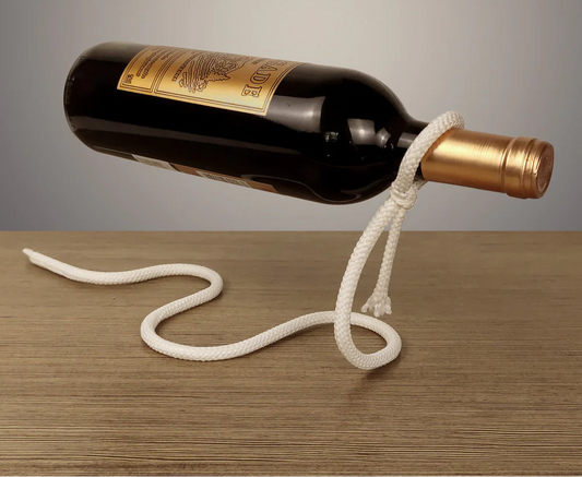 Wine bottle with gold cap tied with rope on a wooden surface, with text overlay.