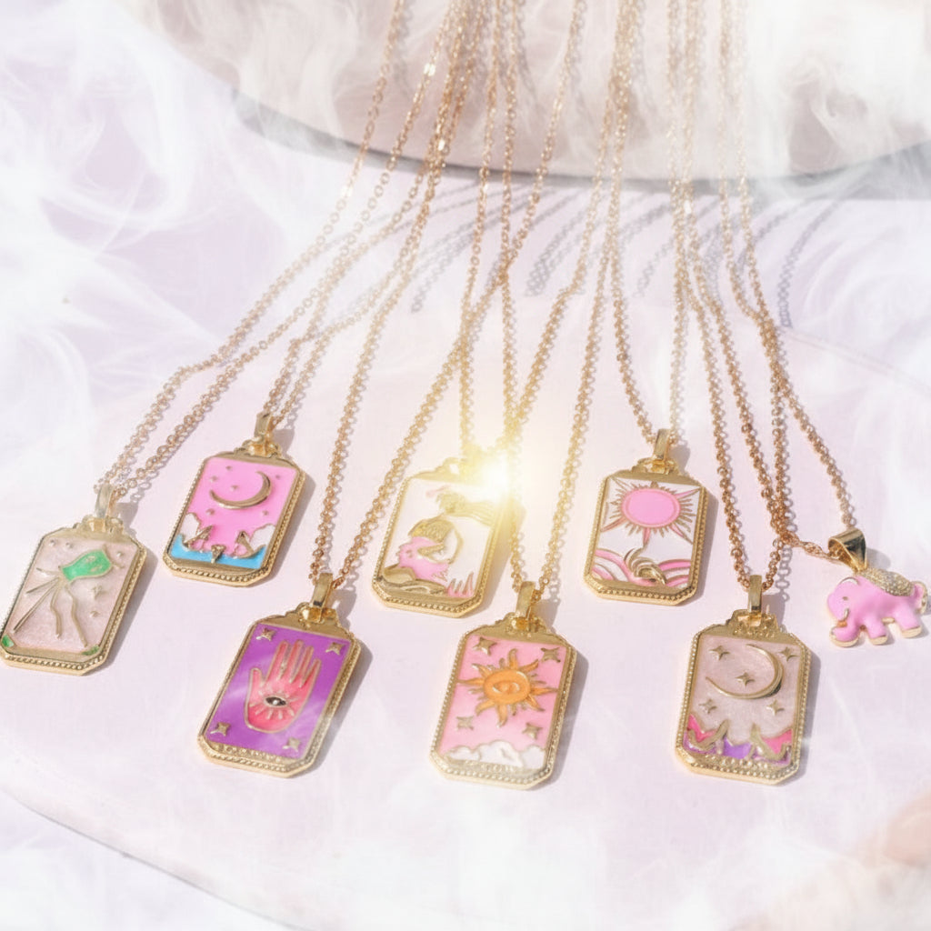 Set of colorful necklaces with various pendants on a white surface
