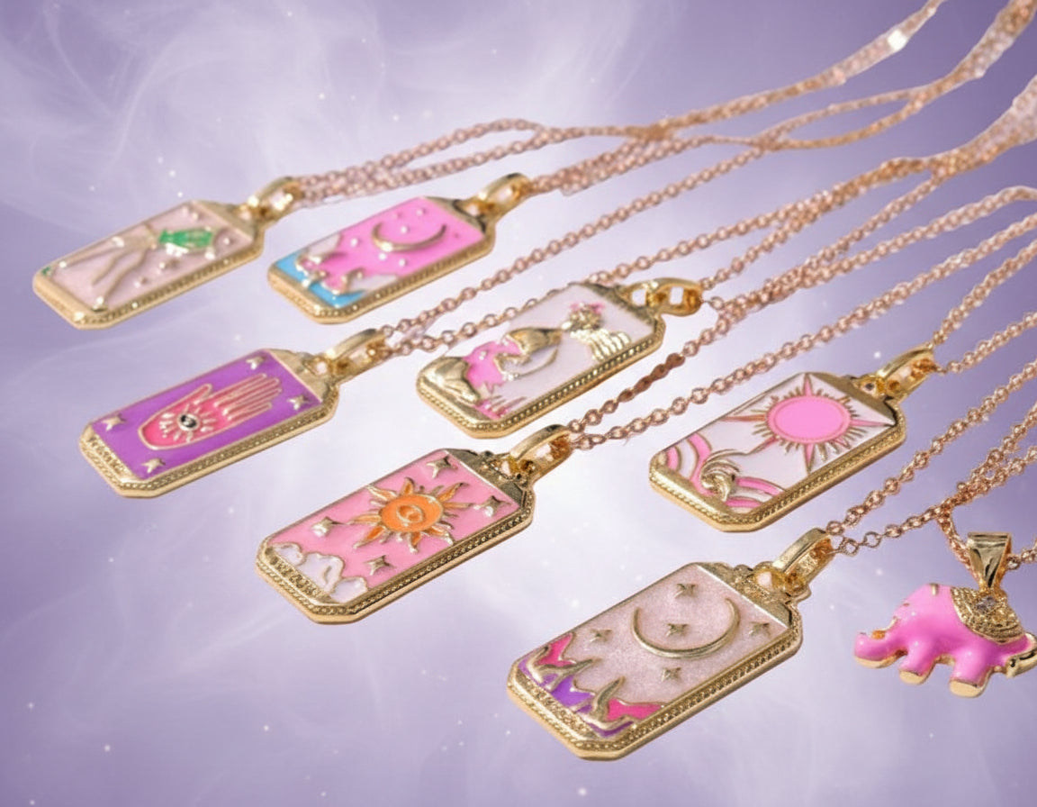 Set of colorful necklaces with various pendants on a white surface