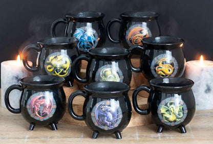 Set of black mugs with dragon designs on a wooden surface with candles in the background.