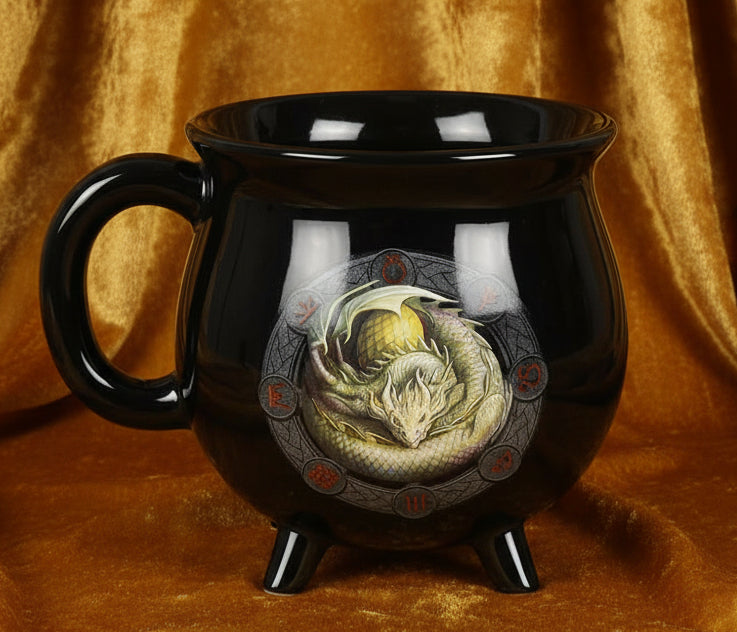 Black mug with a dragon design on a white background