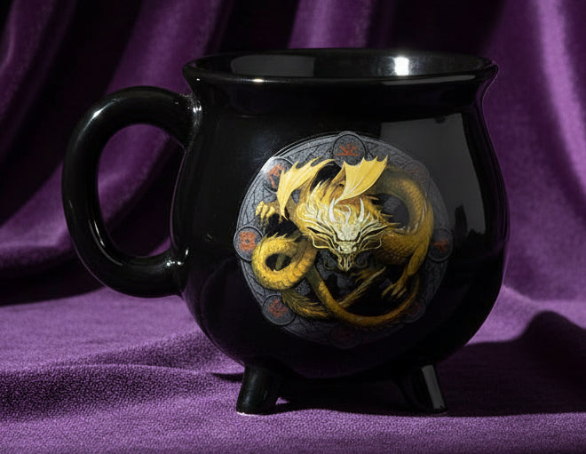 Black mug with a gold dragon design on a white background