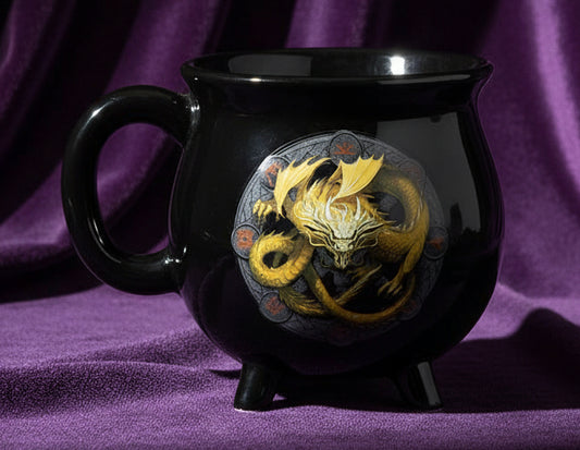 Black mug with a gold dragon design on a white background