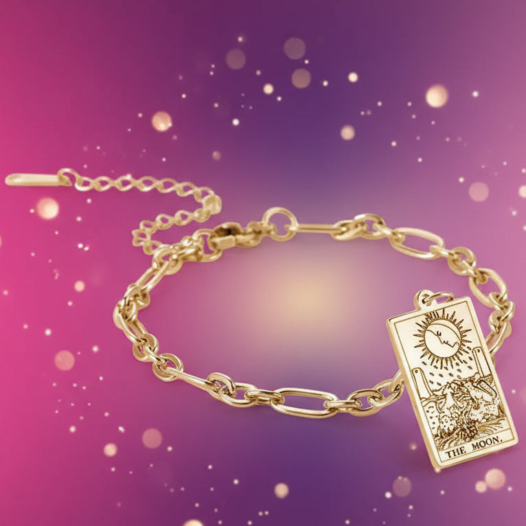 Gold bracelet with a tarot card charm on a white background