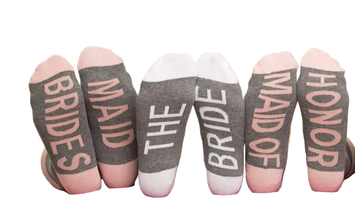 Three women wearing socks with text, sitting on a couch.