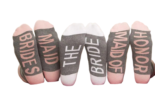 Three women wearing socks with text, sitting on a couch.