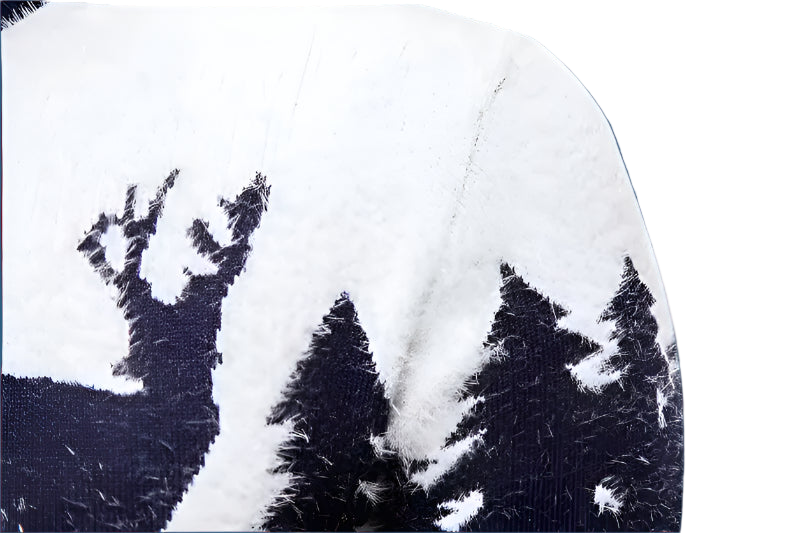 Close-up of a white sweater with black deer pattern on a white background