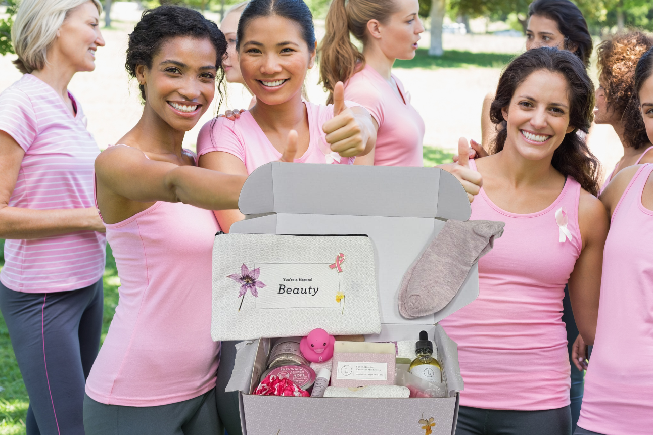 Group of women in pink shirts with a beauty box in a park