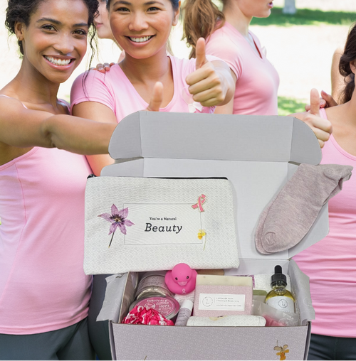 Group of women in pink shirts with a beauty box in a park