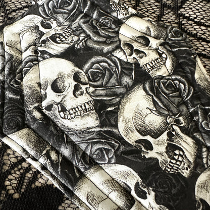 Black and white illustration of skulls and roses on a textured background