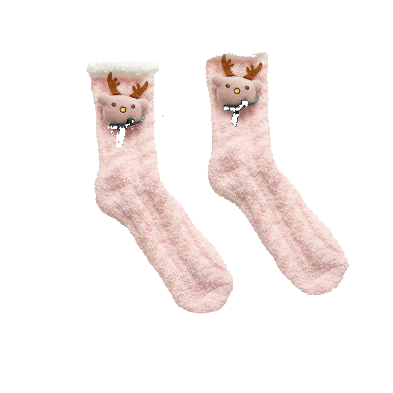 Pair of pink socks with reindeer faces on a fluffy white surface