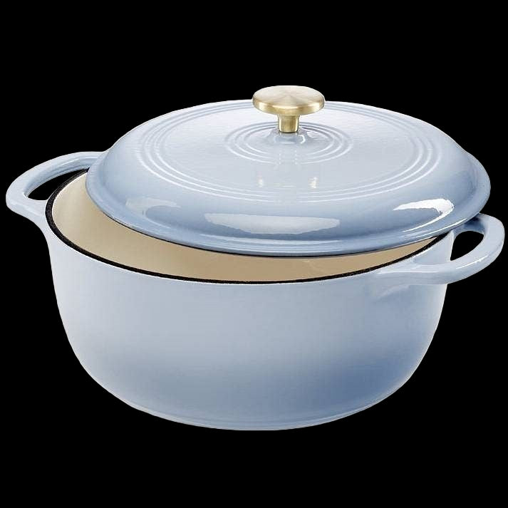 Blue enameled cast iron Dutch oven with a gold lid on a white background