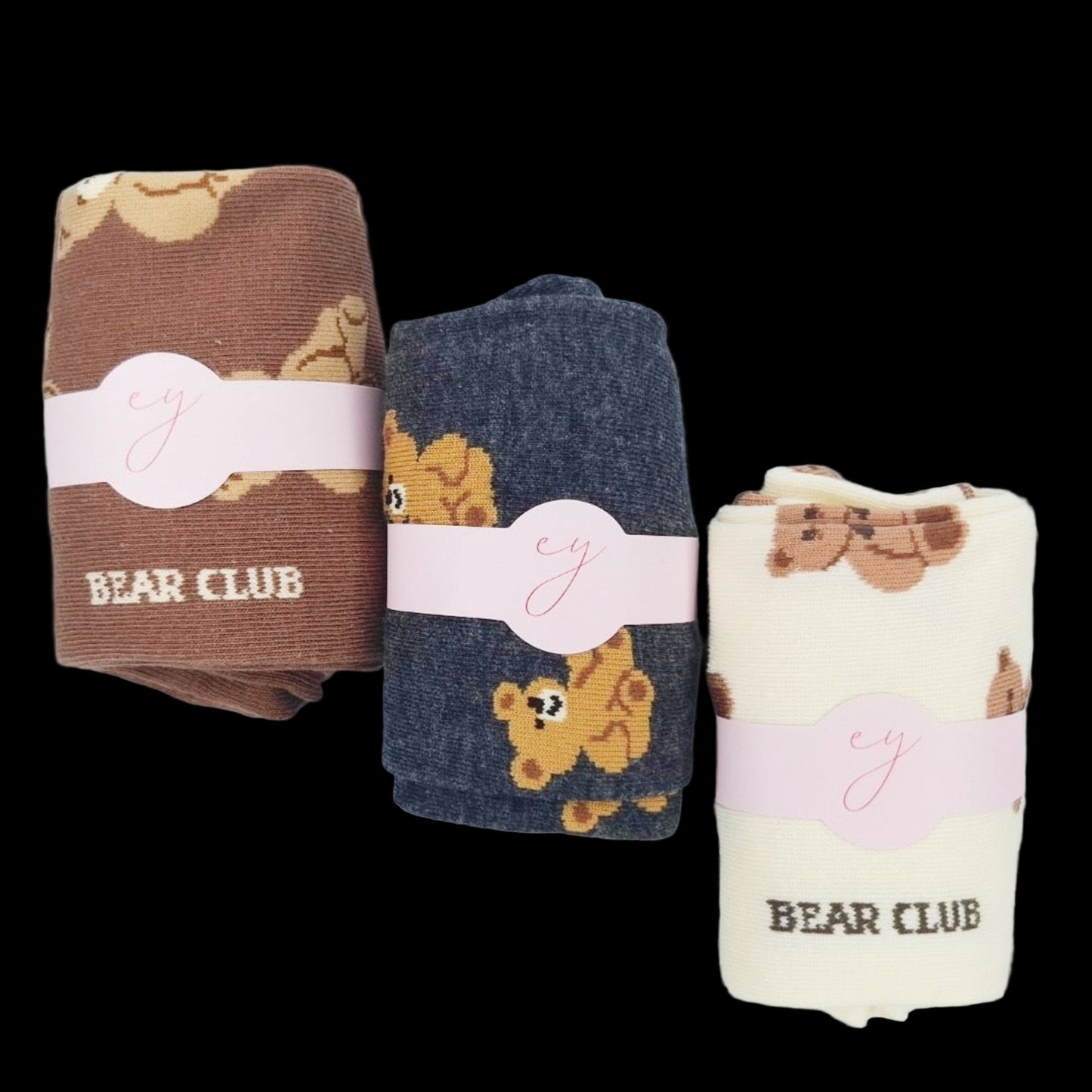 Three folded towels with bear patterns and 'Bear Club' branding on a light background