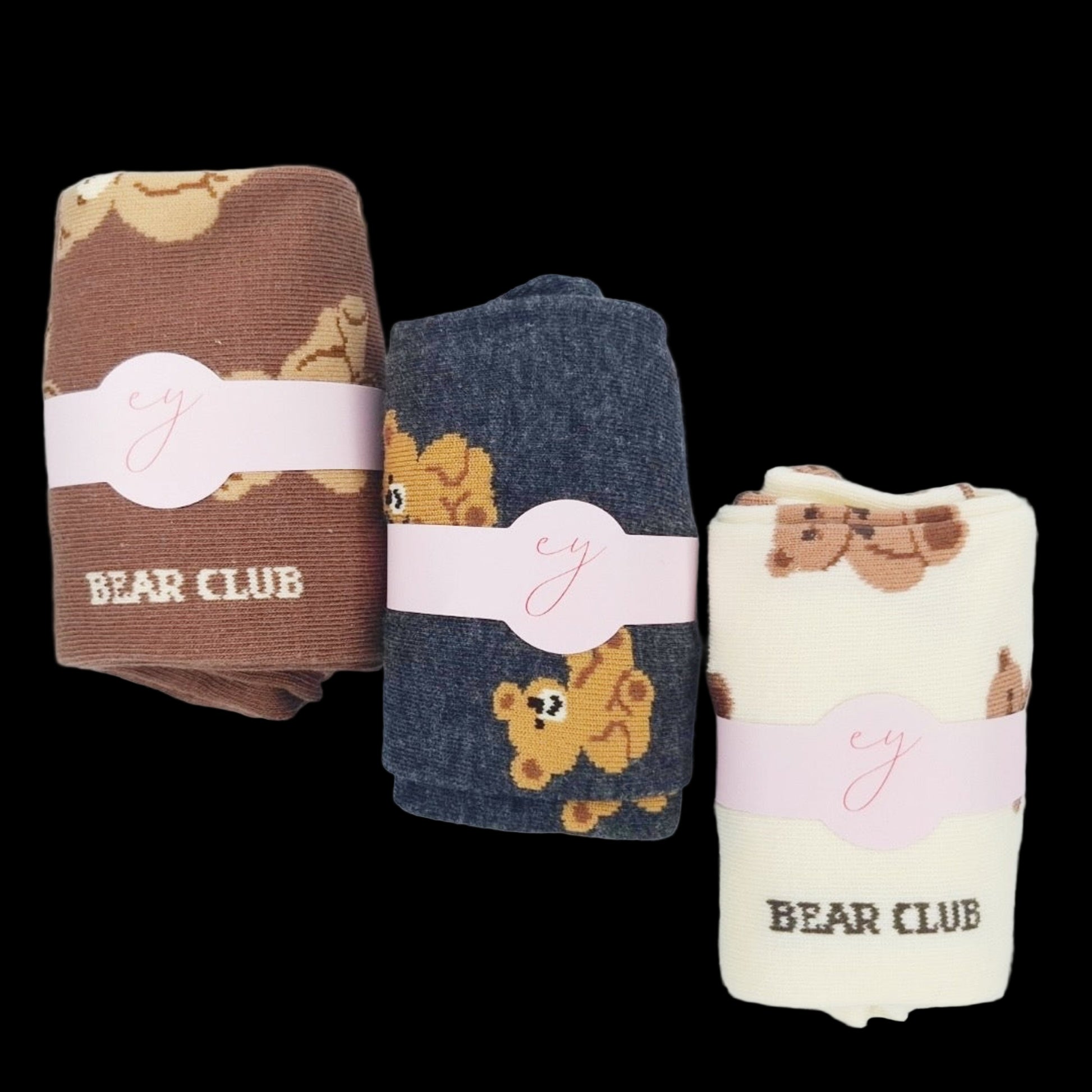 Three folded towels with bear patterns and 'Bear Club' branding on a light background