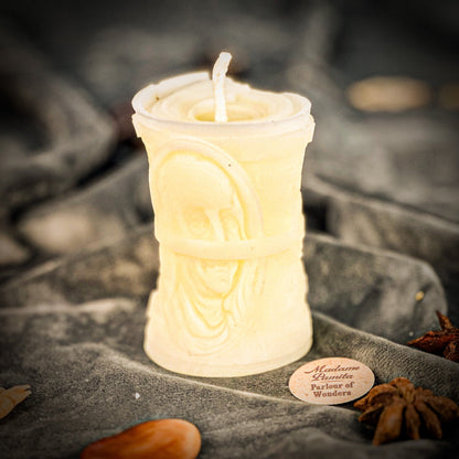 Candle in a decorative container with a blurred background
